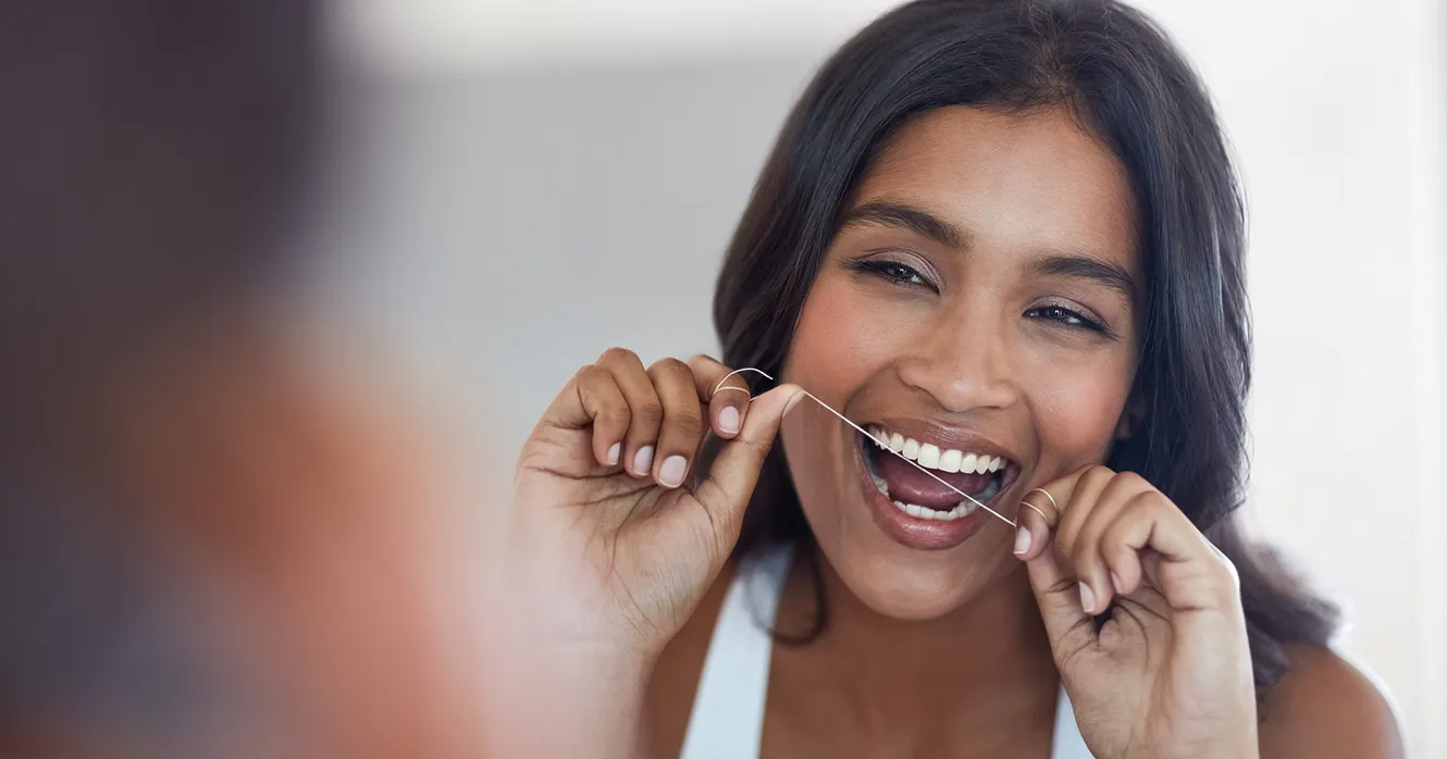 Woman Flossing as Part of Daily Oral Hygiene Routine